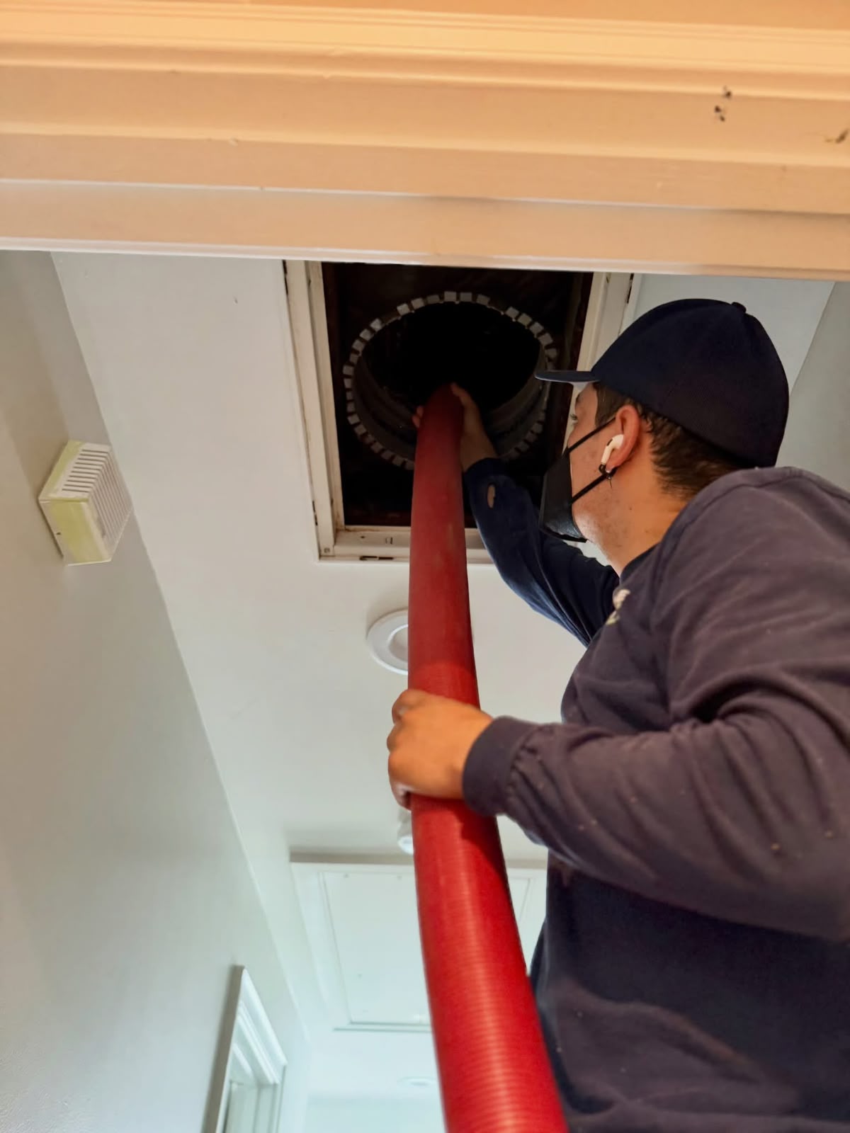 Pristine technician inspecting an HVAC duct system